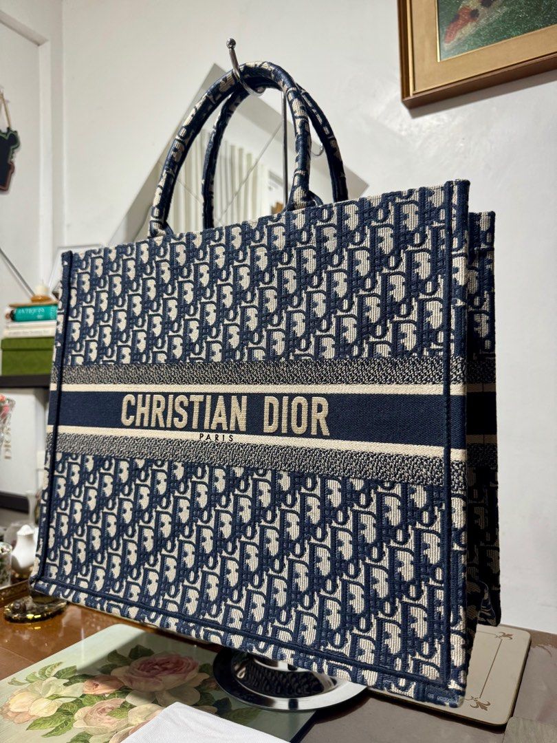 CHRISTIAN DIOR BOOKTOTE OBLIQUE LARGE (Category: Luxury Bags & Wallets) located in Cavite. Submitted by carrycouturebymsu (Listing ID 1379909641, Image 2). Description: • Outer canvas 100% • Color navy blue with two top handles and main compartment • Logo embroidery • 🇯🇵 Self Authentication is advised • Coded/ Made in Italy • Actual pic posted • What you see is what you get Dimensions: 42 x 35 x 18.5 cm Inclusions : Dustbag, card ~ To all buyer