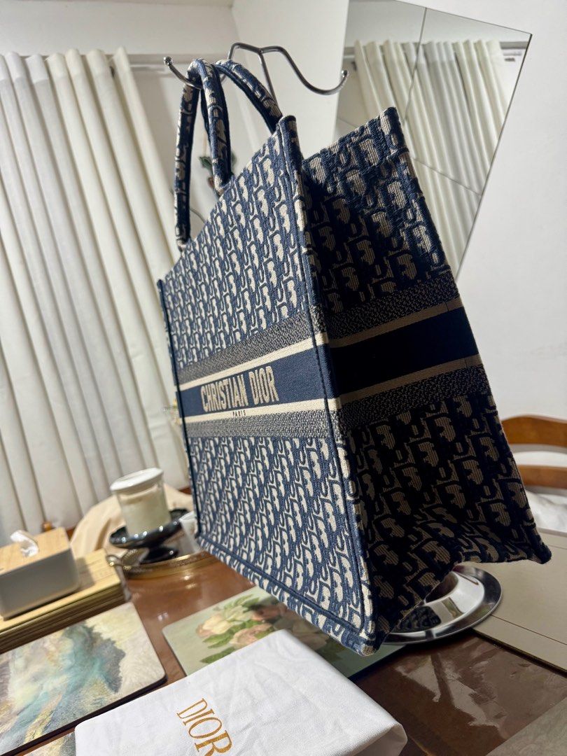 CHRISTIAN DIOR BOOKTOTE OBLIQUE LARGE (Category: Luxury Bags & Wallets) located in Cavite. Submitted by carrycouturebymsu (Listing ID 1379909641, Image 3). Description: • Outer canvas 100% • Color navy blue with two top handles and main compartment • Logo embroidery • 🇯🇵 Self Authentication is advised • Coded/ Made in Italy • Actual pic posted • What you see is what you get Dimensions: 42 x 35 x 18.5 cm Inclusions : Dustbag, card ~ To all buyer