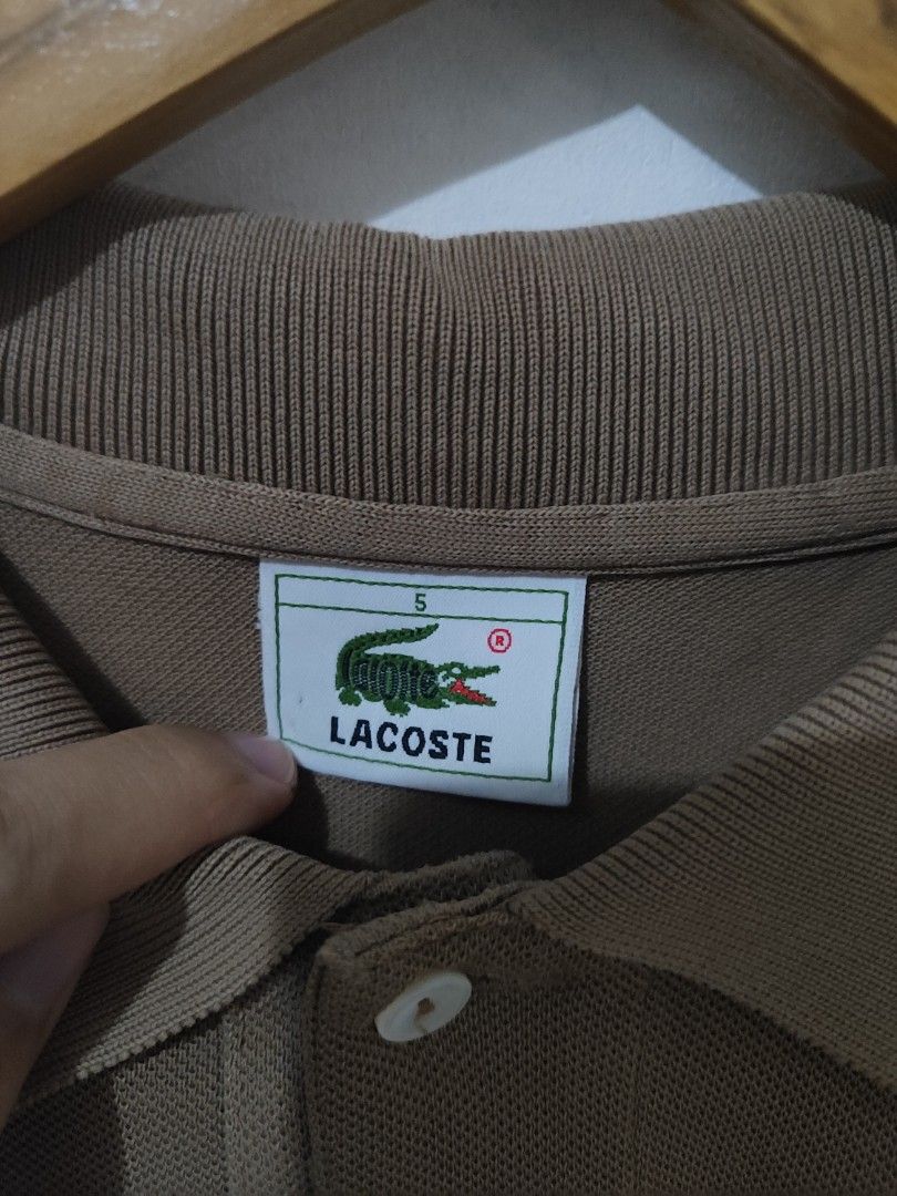 Lacoste Brown Polo Shirt (Category: Tshirts & Polo Shirts ) located in Manila. Submitted by ksayson (Listing ID 1379722831, Image 2). Description: Dimes: 21x28.5 Size on Tag: Size 5 Color Rate; 9/10 Issue: Restitch, fake Price: 150 Location: Manila Decluterring.