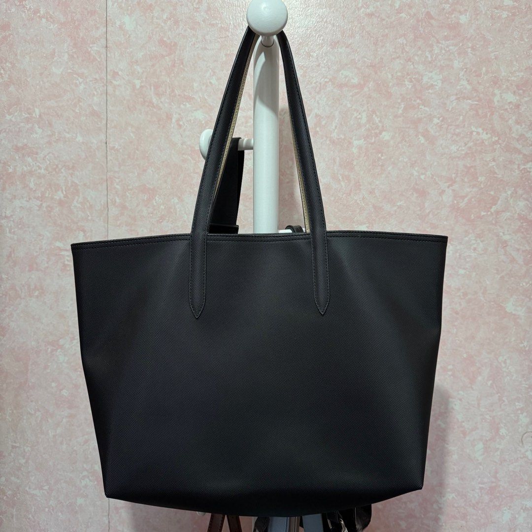 Lacoste Reversible Tote Bag (Black/Cream) (Category: Tote Bags) located in Imus. Submitted by esioul15 (Listing ID 1379862560, Image 2). Description: ‼️ NO TO LOWBALLERS ‼️ - issue: slight bent on the handles - used only for a few times - bought for ₱6950 (see tag in the 8th photo) mop: gcash .