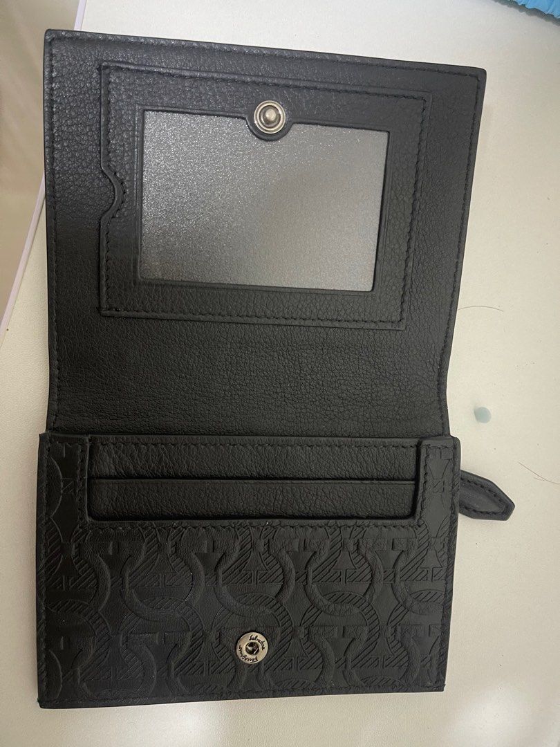 Salvatore Ferragamo Black Leather Card Holder (Category: Bags & Wallets) located in Singapore. Submitted by humanityx (Listing ID 1379905396, Image 1). Description: This Salvatore Ferragamo card holder is in excellent condition. It features a sleek black leather exterior with the iconic Gancini pattern. The interior includes card slots and a clear window for an ID. A stylish and practical accessory. Doesn’t have receipt, but you can go to the sho