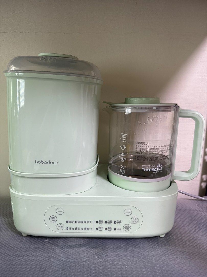 Boboduck Baby Food Maker - Mint Green (Category: Weaning & Toddler Feeding) located in Singapore. Submitted by kimyoke91 (Listing ID 1379928371, Image 1). Description: Boboduck baby food maker in mint green. Features a sterilizer and a milk warmer. Includes multiple function buttons for various uses. Perfect for preparing baby food and milk conveniently. .