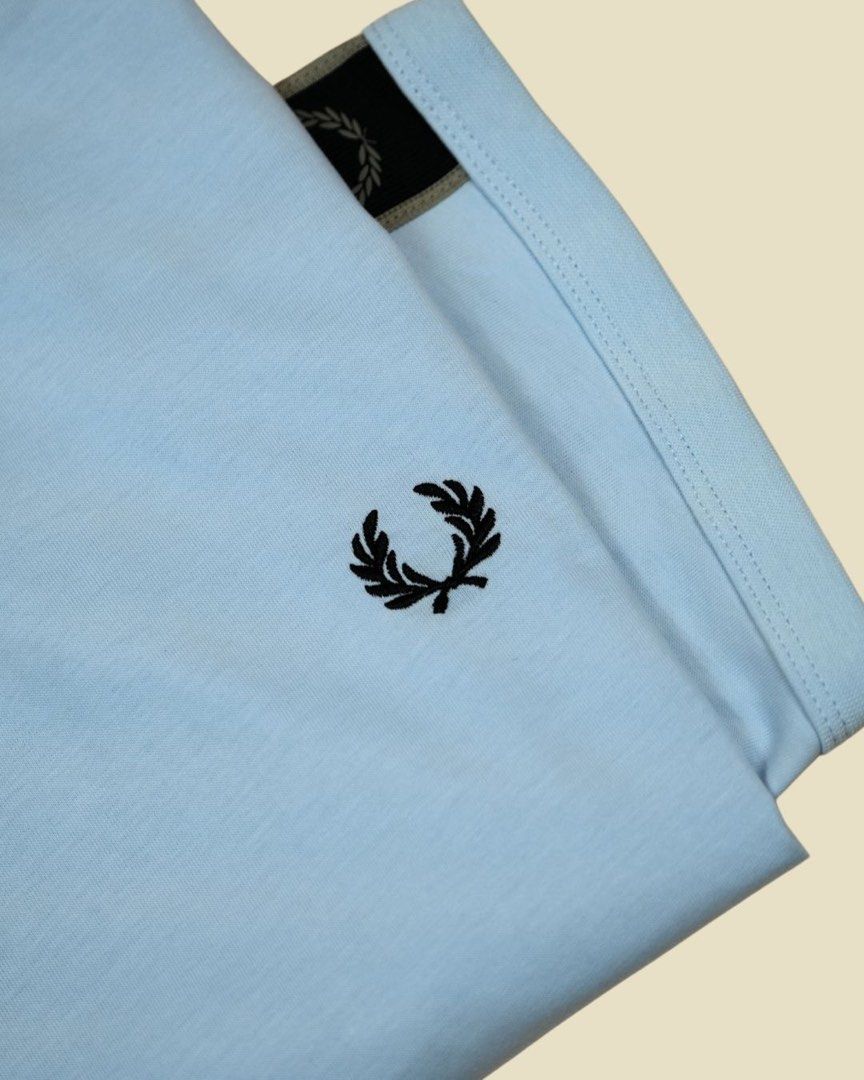 Fred Perry Taped Ringer Shirt with tag (Category: Luxury Apparel) located in Antipolo. Submitted by curatedlabelsph (Listing ID 1380002520, Image 3). Description: Fred Perry Taped Ringer Shirt – M4613 in Light Ice & Black. ✔️ Authentic & brand new ✔️ Cotton jersey fabric ✔️ Regular Fit ✔️ Track tape to shoulder and sleeve ✔️ Ribbed crew neck ITEM CODE: M4613 - S22 Available in L .