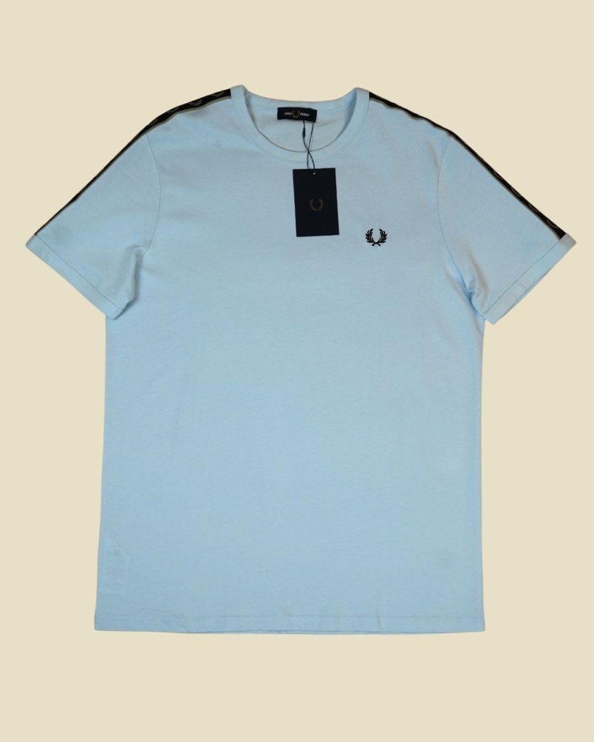 Fred Perry Taped Ringer Shirt with tag (Category: Luxury Apparel) located in Antipolo. Submitted by curatedlabelsph (Listing ID 1380002520, Image 1). Description: Fred Perry Taped Ringer Shirt – M4613 in Light Ice & Black. ✔️ Authentic & brand new ✔️ Cotton jersey fabric ✔️ Regular Fit ✔️ Track tape to shoulder and sleeve ✔️ Ribbed crew neck ITEM CODE: M4613 - S22 Available in L .