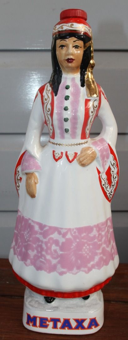 Preloved Vintage Hand-Painted Ceramic Metaxa Bottle, Female Figurine (Category: Kitchen & Appliances) located in Burnie. Submitted by tasmanianbeauties (Listing ID 1380093143, Image 2). Description: Preloved Vintage Hand-Painted Ceramic Metaxa Bottle, Female Figurine This decanter stands 32cm tall and has base measurements of 9.2cm x 7.8cm. It is empty. It is made in Greece It has no chips or cracks, and the pattern is well preserved. It has a st