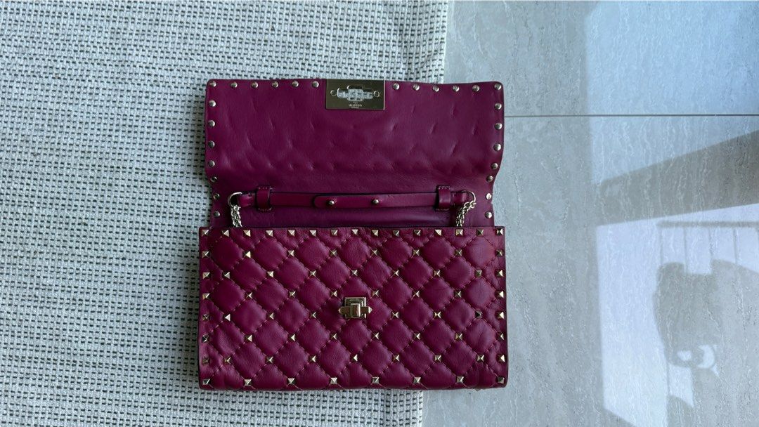 Valentino Garavani Rockstud Quilted Wallet (Category: Bags & Wallets) located in Singapore. Submitted by il_____ (Listing ID 1379930968, Image 2). Description: Beautiful Valentino Garavani Rockstud wallet in excellent condition. Features a quilted design with signature Rockstud embellishments. The wallet has a secure clasp closure. A stylish and practical accessory..