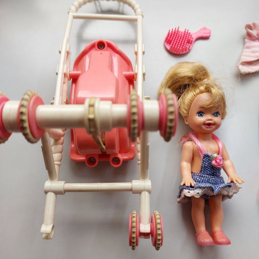 Barbie 90s Kelly Strollin Fun (Category: Kids Toys) located in San Juan City. Submitted by peachykr (Listing ID 1380161025, Image 3). Description: Barbie - Kelly - Strollin' Fun Toys from the 90s. Kelly's back has a mechanism to make her wave. This can be moved manually or when the stroller is pushed while she sits down on it. Stroller is missing one wheel and other parts. Will need some fix to fully function. Please expect typical wear and tear.