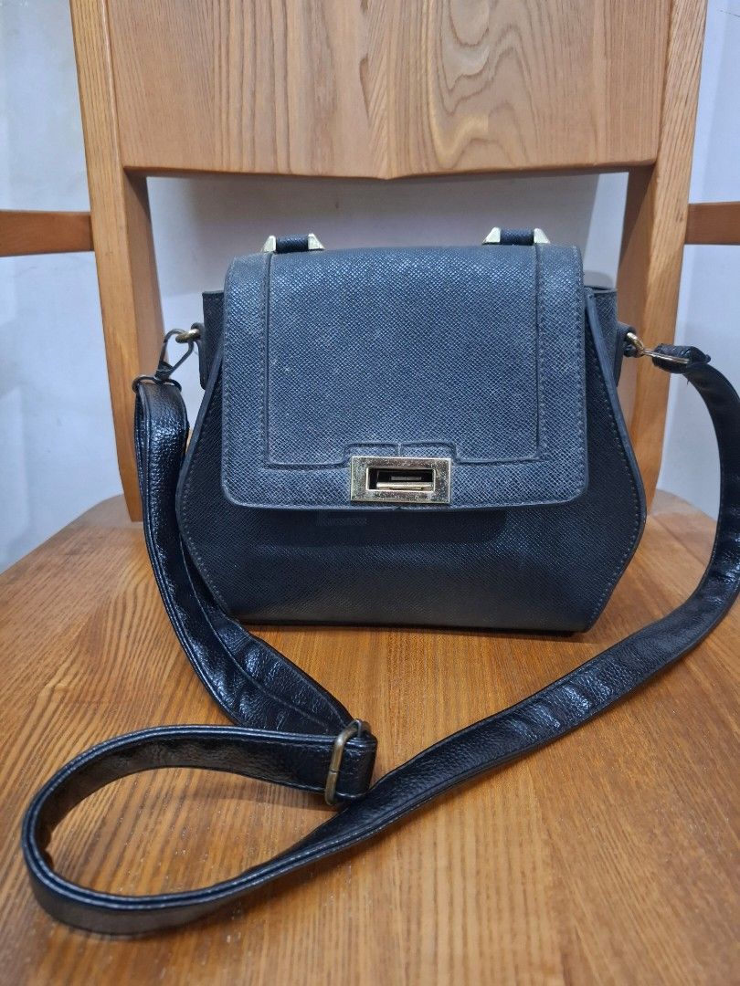 Black bag (both body and purse bag) (Category: Cross-body Bags) located in Quezon City. Submitted by wise_r (Listing ID 1380127036, Image 3). Description: PM if interested Bag: 1. Black bag 2. Big space inside and can hold a lot of items. 3. The bag is very sturdy, and has a tire-like skin exterior. Defects: 1. The strap hook, but nothing that cannot be replaced. 2. Some metal accents are fading but not rusting and can be polished. Reminder: - Th