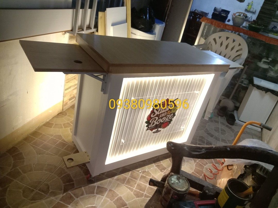 Collapsible mobile cart (Category: Tables & Sets) located in Manila. Submitted by efghiwoodwork (Listing ID 1380110134, Image 2). Description: 6k only collapsible mobile cart ✨ ✅ Lights ✅ Wheels ✅ Painted/varnished 7k only collapsible mobile cart w/side table ✨ ✅ Lights ✅ Wheels ✅ Painted/varnished ✅Side table customize additional 2k for acrylic logo,fluted panel, hydraulic,etc. Location CAMARIN CALOOCAN 📍.