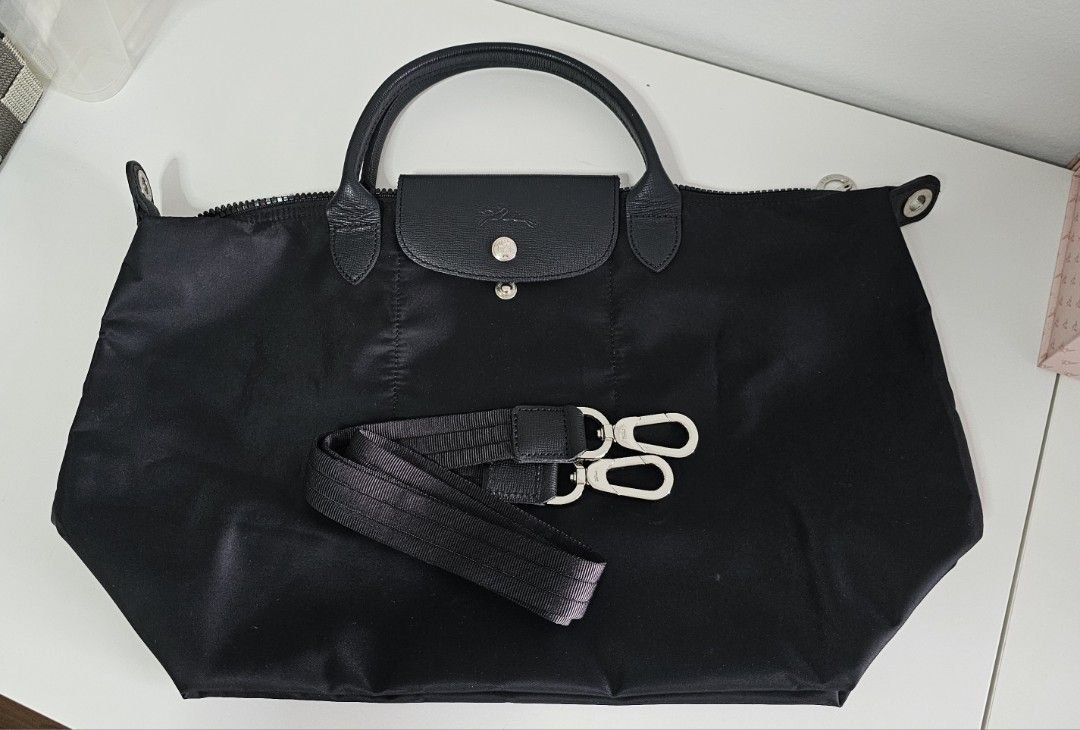 Longchamp Tote Bag - Black Authentic (Category: Bags & Wallets) located in Singapore. Submitted by baby2vnow (Listing ID 1380132633, Image 1). Description: Selling Longchamp Tote Bag Short Handle with detachable Bag Strap 45cm x 27cm Bag and strap only. Bought long time ago. Used less than 5 times, stored and neglected. Finding a new owner who can use this piece properly. Pls note that there is some bent mark at the back of the bag. Refer to last