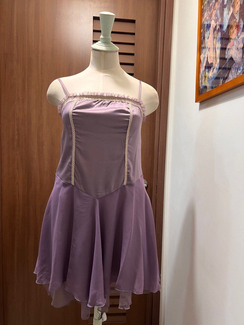 Sweet Lilac Ruffle Trim Dress (Category: Dresses) located in Singapore. Submitted by minni3scloset (Listing ID 1380189699, Image 1). Description: Add a touch of romantic charm to your wardrobe with this sweet lilac mini dress. Designed with a flattering sweetheart-inspired neckline and delicate cream lace trim, this piece is perfect for weekend brunches, dates, or springtime strolls. The softly flared asymmetrical hemline adds graceful movement, 