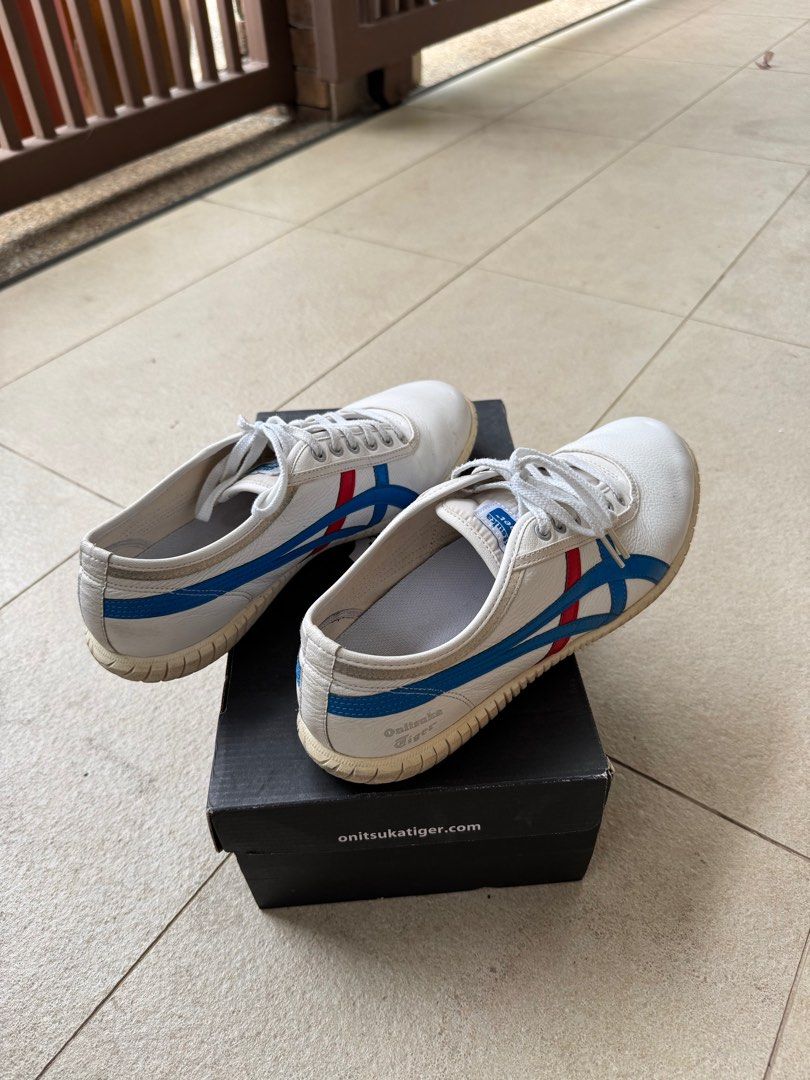 Onitsuka Tiger Tsunahiki 1183A084 White/Blue (Category: Casual shoes) located in Singapore. Submitted by limts89 (Listing ID 1380190583, Image 2). Description: Onitsuka Tiger Tsunahiki sneakers in white with blue and red stripes. Size 10.5 US Men's / 12 US Women's. Comes with original box and receipt. Lightly used, as seen in the pictures. Soles show some wear..