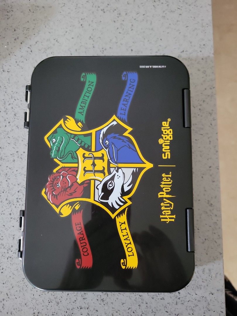 Smiggle Harry Potter Lunchbox (Category: Food Organisation & Storage) located in Singapore. Submitted by lpguo199851881 (Listing ID 1380144186, Image 1). Description: - Smiggle Harry Potter lunchbox in excellent condition. - Features a black exterior. - Adorned with the Hogwarts crest. - Includes multiple compartments for food separation. - Perfect for Harry Potter enthusiasts!.