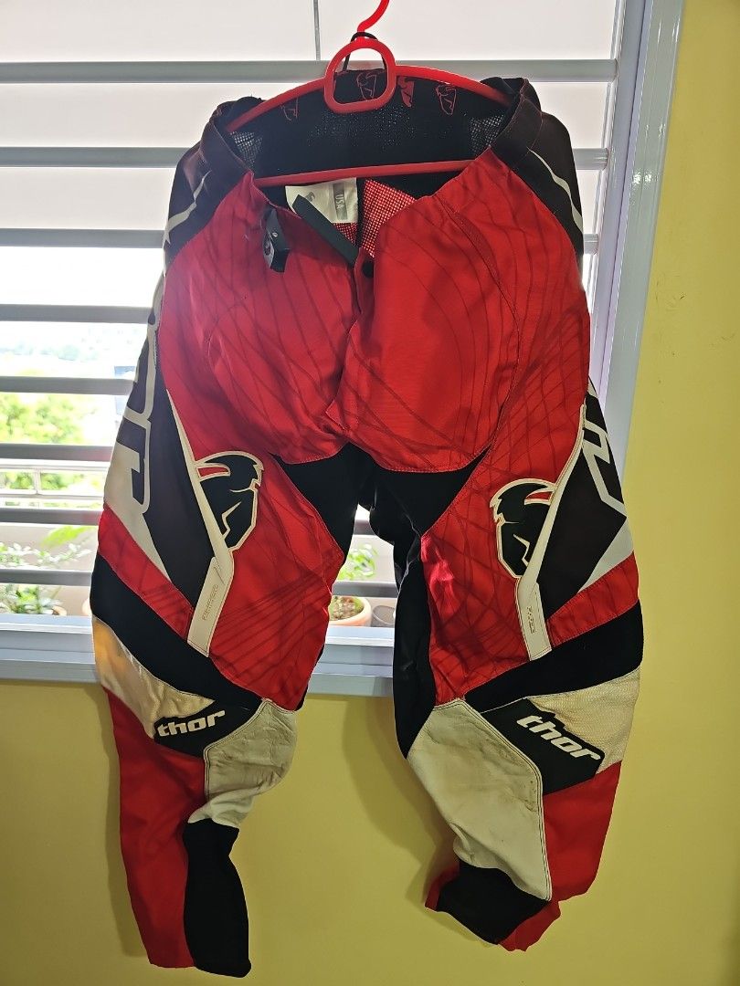 Thor Motorcycle Pants - Red, Black, White - Size 34 (Category: Motorcycle Apparel) located in Singapore. Submitted by cucunenek13 (Listing ID 1380133554, Image 1). Description: - Thor motorcycle pants - Size 34 - Good condition - Eye-catching red, black, and white design - Well-maintained - Ideal for motorcycle riders.