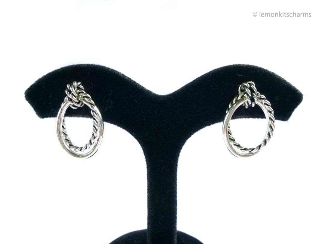 Vintage 1990s Silvertone Roped Doorknocker Pierced Earrings, er2691-ci (Category: Earrings) located in Singapore. Submitted by lemonkitscharms (Listing ID 1380134505, Image 2). Description: Vintage 1990s - Y2K Silvertone Roped Doorknocker Styled Earrings, for pierced ears. Clutches are new. Very good condition. Double interlooping oval rings with roped design. Price excludes postage. Check my profile for postage rates. Size: 26 x 17mm - Sorry NO 