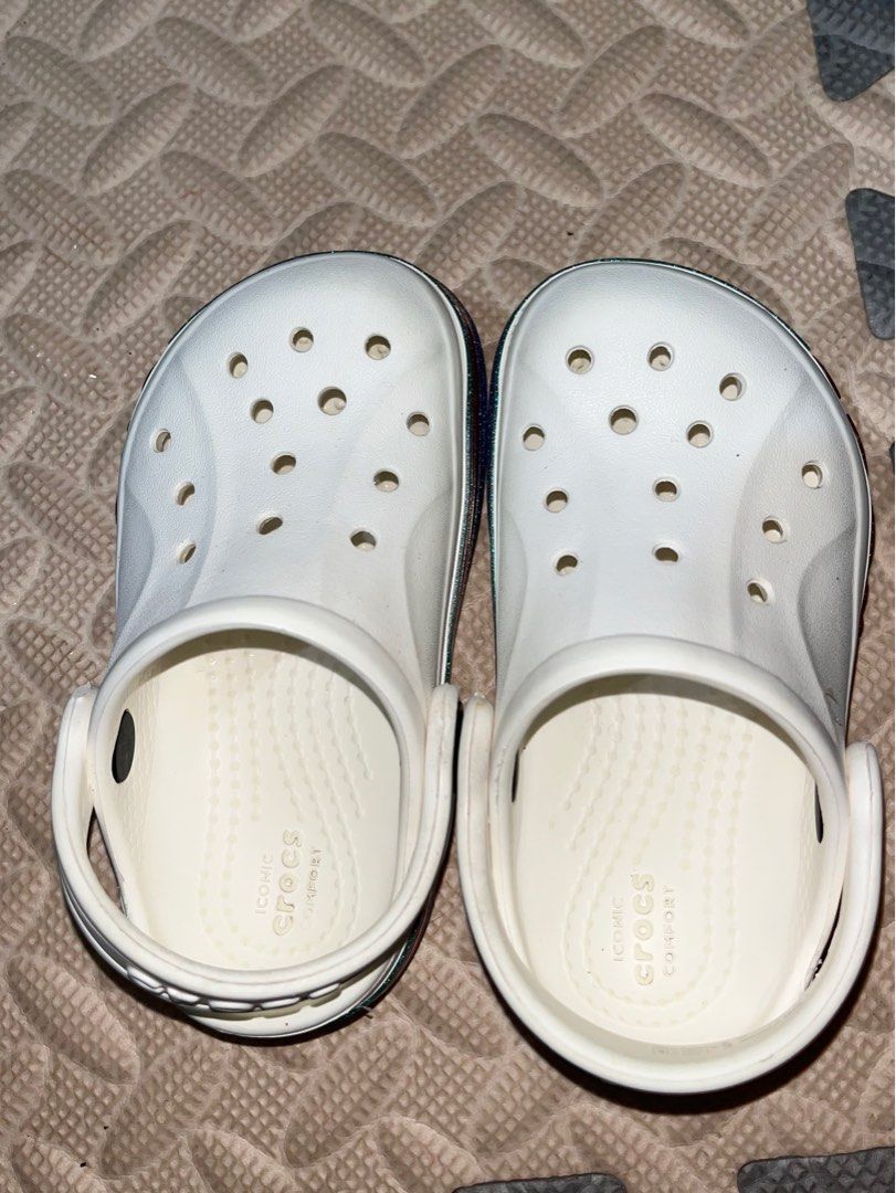 Authentic Crocs toddler bayaband white rainbow glitter clog (Category: Babies & Kids Fashion) located in Bulacan. Submitted by solovedbyjel (Listing ID 1380451548, Image 3). Description: Swipe to see more pics and condition of the slippers. Size C6! Can be unisex. Negotiable price..