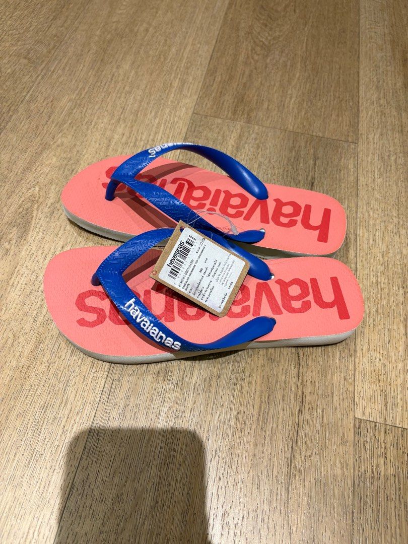 Havaianas Flip-Flops - Brand New (Category: Flipflops and Slides) located in Singapore. Submitted by baobaojj (Listing ID 1380435842, Image 1). Description: Brand new Havaianas flip-flops. Features a coral pink base with blue straps. Comes with original tags attached. Perfect for the beach or casual wear. Size is indicated on the tag. Size 37/38.