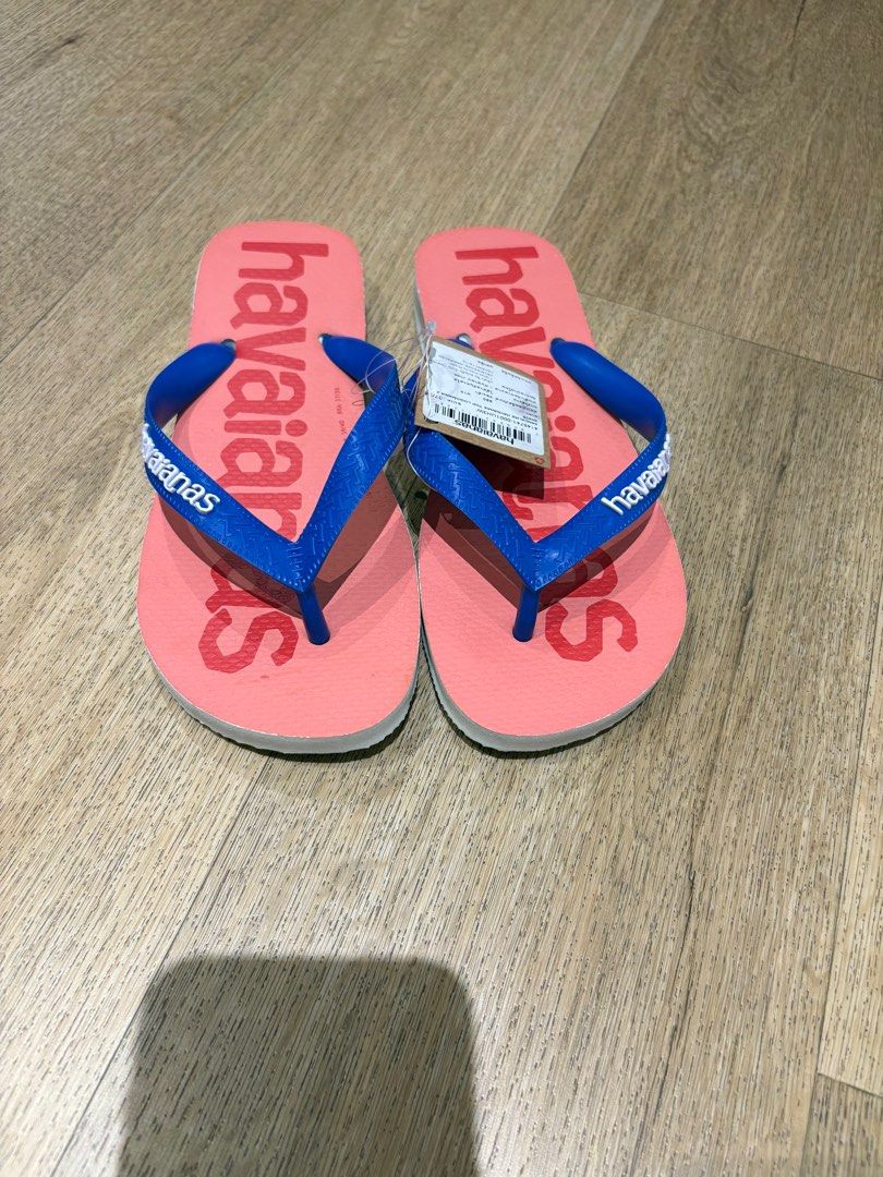 Havaianas Flip-Flops - Brand New (Category: Flipflops and Slides) located in Singapore. Submitted by baobaojj (Listing ID 1380435842, Image 2). Description: Brand new Havaianas flip-flops. Features a coral pink base with blue straps. Comes with original tags attached. Perfect for the beach or casual wear. Size is indicated on the tag. Size 37/38.
