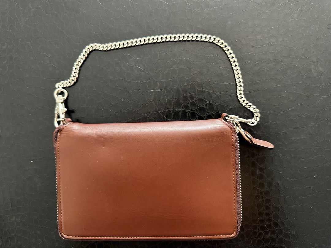 JPG Leather Wallet with Chain (Category: Purses & Pouches) located in Singapore. Submitted by refreshlife (Listing ID 1380335922, Image 2). Description: - Brown leather wallet with a silver chain - can be used as a simple bag - Silver chain can be detached to be used as a regular wallet. - Zip all around closure - Features multiple card slots and compartments. - The wallet has a zip closure and a small coin pocket. - The JPG logo is visible on th