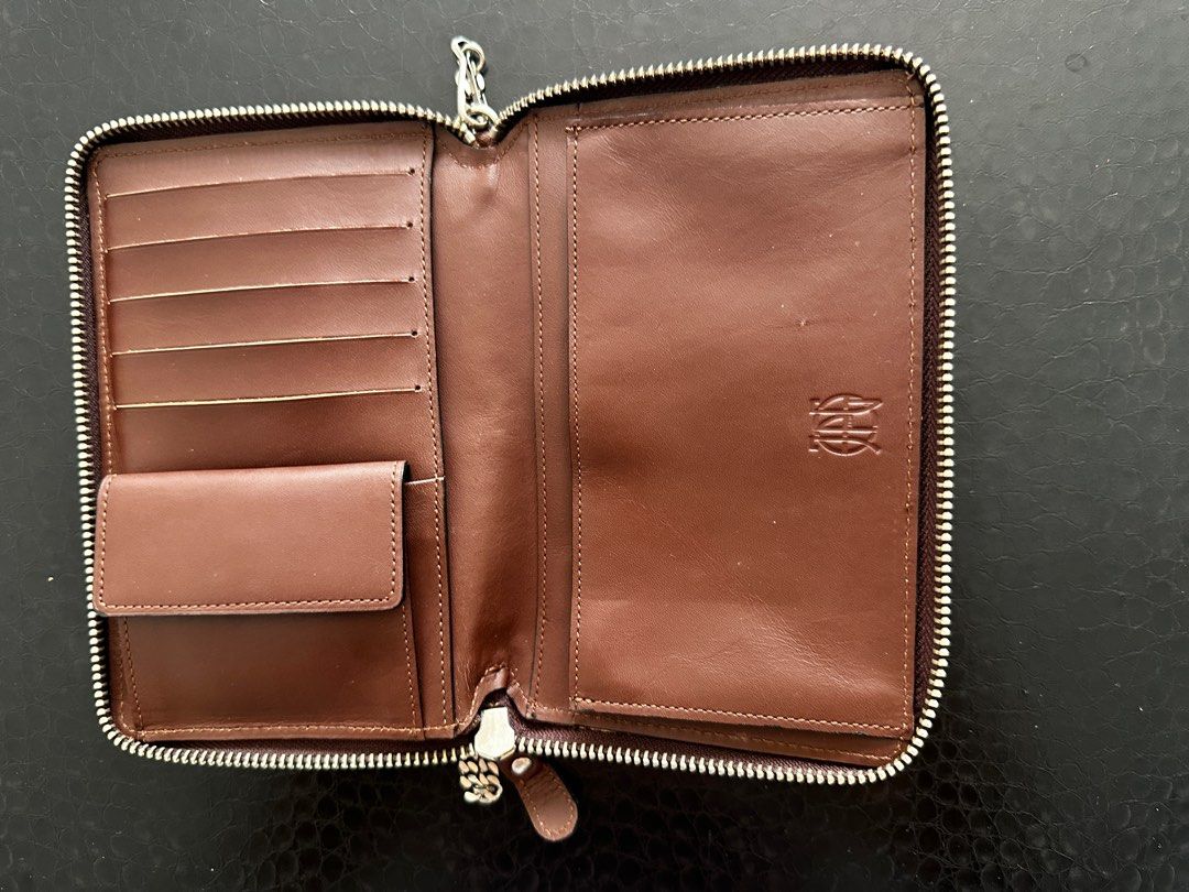 JPG Leather Wallet with Chain (Category: Purses & Pouches) located in Singapore. Submitted by refreshlife (Listing ID 1380335922, Image 3). Description: - Brown leather wallet with a silver chain - can be used as a simple bag - Silver chain can be detached to be used as a regular wallet. - Zip all around closure - Features multiple card slots and compartments. - The wallet has a zip closure and a small coin pocket. - The JPG logo is visible on th