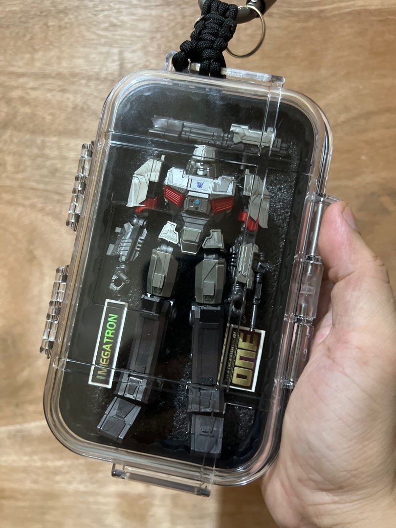 MEGATRON The ONE bag accessory (Category: Action & Battle Toys) located in Manila. Submitted by .stocklist. (Listing ID 1380476753, Image 1). Description: MEGATRON - Transformers Transformer action figure scale 1/144 (144mm) in clear case weather sealed container with paracord and crabiners. Custom backing design cut from its box. (Delivery charges not included).