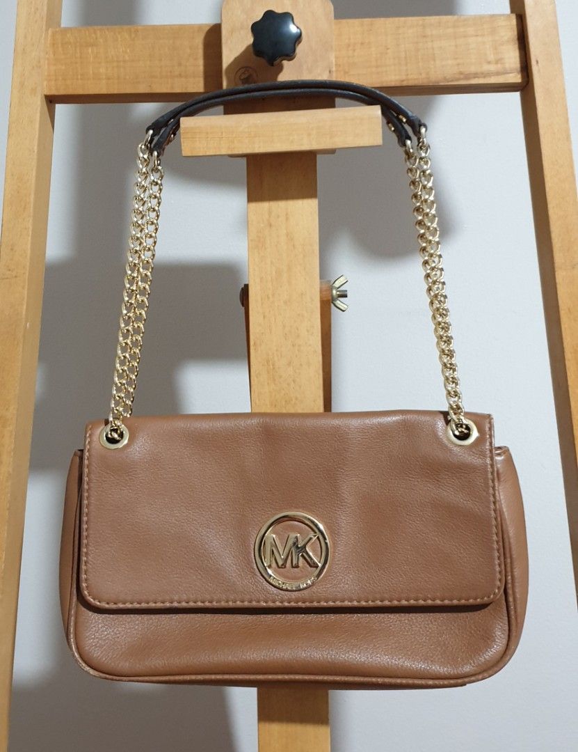 Michael Kors (Category: Luxury Bags & Wallets) located in Quezon City. Submitted by tindahan_nia (Listing ID 1380463535, Image 1). Description: Michael Kors fulton hand bag/ shoulder bag flap closure. For jeans or casual look. Logo with scratches. Can be a shoulder bag or a cross body bag. Free Kate Spade bag, (heavy flaws are only obvious in the inside of the bag).
