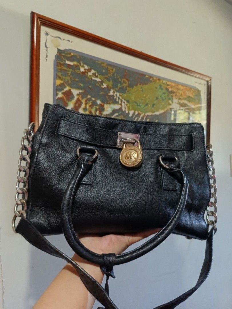 Michael Kors Hamilton 2 Way Bag (Category: Luxury Bags & Wallets) located in Baguio. Submitted by brooks.luxuries (Listing ID 1380309838, Image 2). Description: - has flaws like scratches and discoloration on the hardwares - cracks on the leather - signs of usage on the leather - damaged key for the padlock (scroll on the pics for reference).