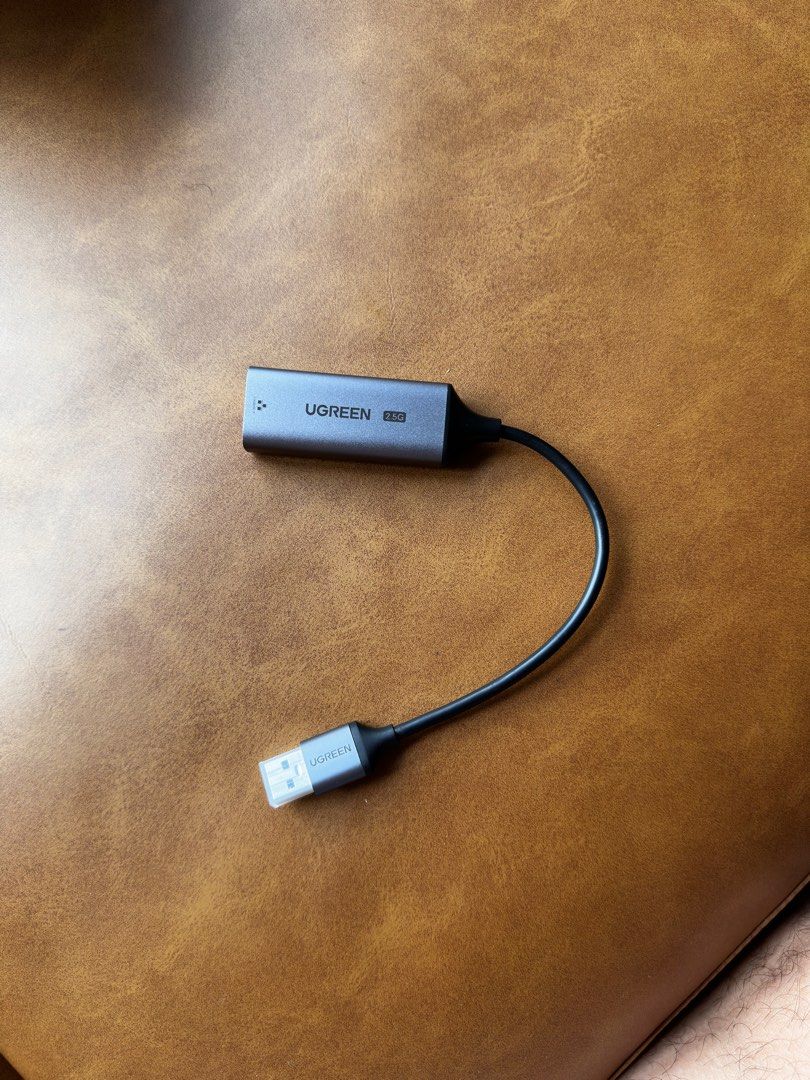 Ugreen USB-A to RJ45 2.5G Ethernet Adapter (Category: Cables & Adaptors) located in Singapore. Submitted by turly221 (Listing ID 1380360672, Image 1). Description: This Ugreen USB-A to RJ45 2.0G Ethernet Adapter is in excellent condition. It allows you to connect to a wired network via USB. The adapter is compact and easy to use. Perfect for laptops or devices without a built-in Ethernet port..