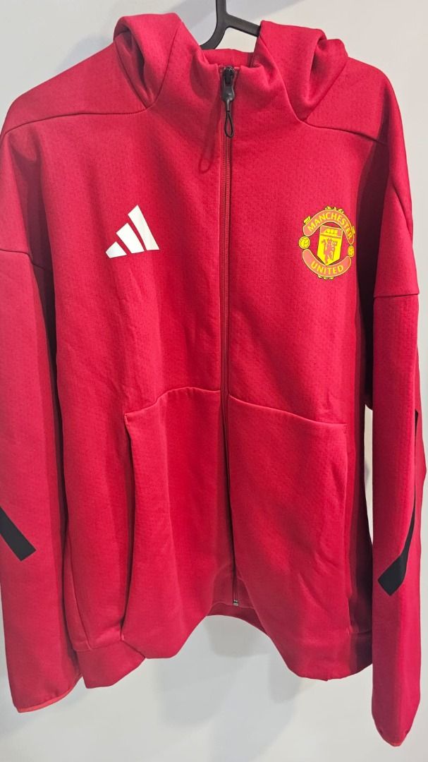 Adidas Manchester United Hoodie - Red - Size L (Category: Coats, Jackets and Outerwear) located in Singapore. Submitted by kyzre96 (Listing ID 1380506497, Image 2). Description: Official Adidas Manchester United hoodie in red. Features the team crest and Adidas logo. Has a full zip and a hood. Size L. Made in Cambodia. Great for any Man U fan! Got it as a gift last month. Wrong size. Oversize for me. Never use and never wash. Follow the Asian Siz