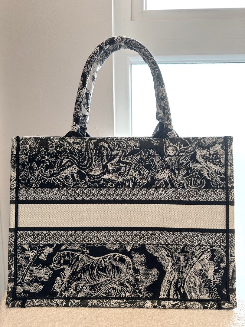 Christian Dior Book Tote Bag (Medium) (Category: Bags & Wallets) located in Singapore. Submitted by pookiecookiiii (Listing ID 1380574519, Image 2). Description: The bag is in excellent condition, with minimal signs of wear. Bought in 2022 and only carried it twice. The cardboard pieces are inserted to maintain the shape of the bag and it is still structured and in excellent condition. I only have the dust bag as I threw away the box, thinking th