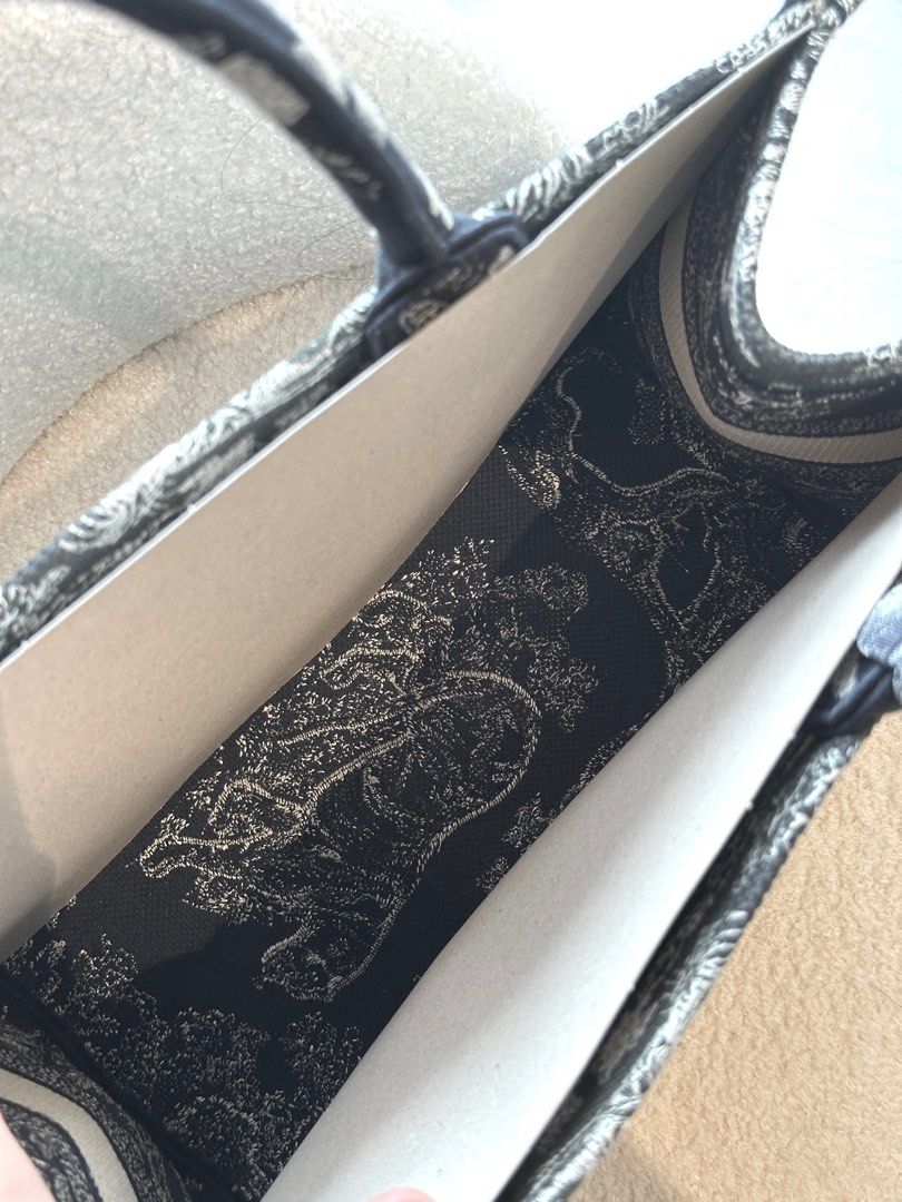 Christian Dior Book Tote Bag (Medium) (Category: Bags & Wallets) located in Singapore. Submitted by pookiecookiiii (Listing ID 1380574519, Image 3). Description: The bag is in excellent condition, with minimal signs of wear. Bought in 2022 and only carried it twice. The cardboard pieces are inserted to maintain the shape of the bag and it is still structured and in excellent condition. I only have the dust bag as I threw away the box, thinking th