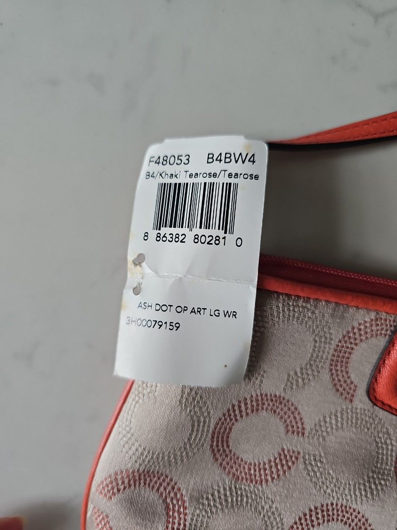 Coach Ash Dot Op Art Wristlet (Category: Bags & Wallets) located in Singapore. Submitted by Lemon_Chamomile (Listing ID 1380607913, Image 2). Description: - Brand new Coach wristlet - Ash Dot Op Art design - Comes with original box and tags - Features coral-colored wrist strap and accents - Received as farewell gift, never use before - Ideal for carrying essentials stylishly - Inner compartment has 8 cards slot - Length from top is Abt 21 cm.