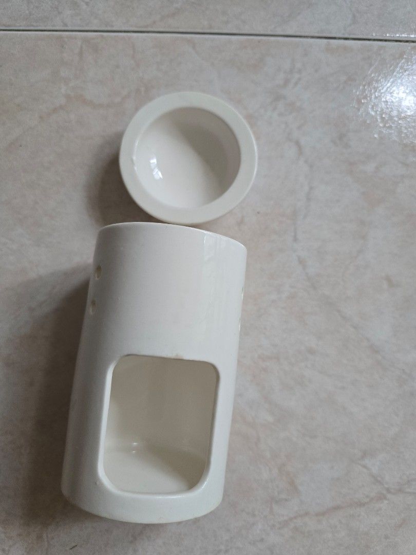 Essential Oil Diffuser (Category: Other Home Decor) located in Singapore. Submitted by mamasoon (Listing ID 1380573049, Image 2). Description: - White ceramic container - Circular lid - Rectangular front opening - Drop a few drops of essential oil to the top and place a small candle below. .