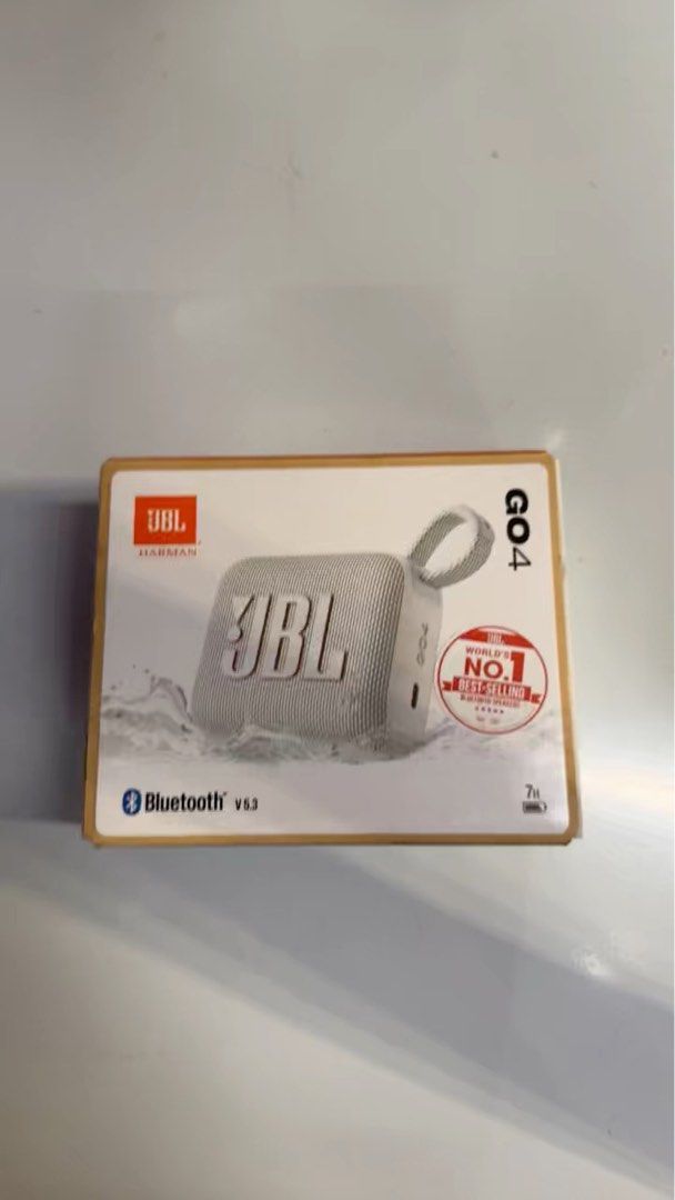 JBL GO4 Portable Bluetooth Speaker - White (Category: Soundbars, Speakers & Amplifiers) located in Singapore. Submitted by greatvaluematters (Listing ID 1380555271, Image 1). Description: Hey there! Selling this brand new JBL GO4 portable Bluetooth speaker. It's the white version, and it's still in its original packaging. The box is in great condition, and you can see it's a best-selling model. It has Bluetooth v5.3, so you can easily connect you