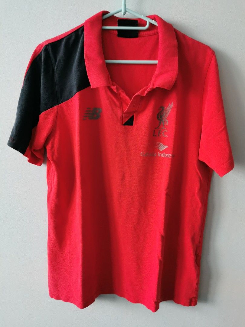 New Balance Liverpool Polo T-shirt (Category: Tshirts & Polo Shirts) located in Singapore. Submitted by xlcrap2210 (Listing ID 1380579733, Image 1). Description: This is a red Liverpool polo t-shirt from New Balance. It has a black panel on the side. The size is M. The t-shirt is in good condition. It is a great addition to any Liverpool fan's wardrobe. It is perfect for casual wear or for showing your support for the team. The t-shirt is made of