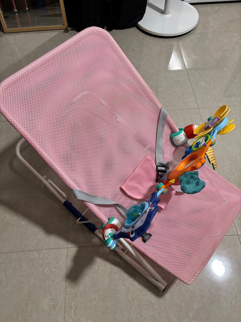 Bouncer - Pink with Toy Bar (Category: Infant Playtime) located in Singapore. Submitted by whiskeybabu (Listing ID 1380836973, Image 1). Description: Gently used bouncer in pink. Includes toy bar. The mesh fabric is breathable and easy to clean. Perfect for keeping your baby entertained and comfortable. From a smoke-free home..