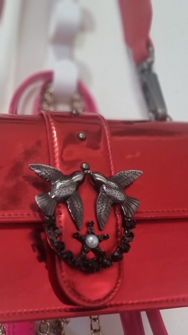 Pinko (Category: Luxury Bags & Wallets) located in Cagayan de Oro. Submitted by tommygurl1218 (Listing ID 1380759208, Image 3). Description: glossy red, shoulder bag with 2 missing black stones on front (not directly noticeable though).