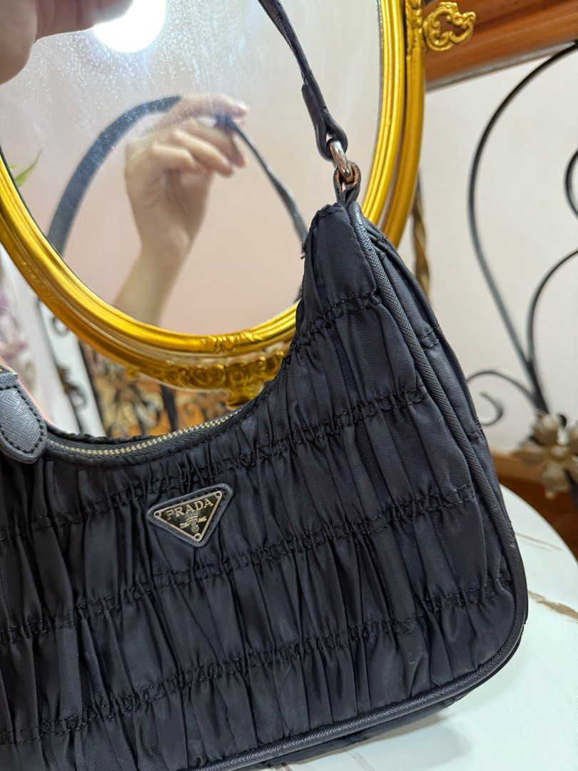 Prada ruched hobo bag (Category: Luxury Bags & Wallets) located in Limay. Submitted by fashionshop248 (Listing ID 1380854340, Image 2). Description: Preloved! -flaw sa may stain sa loob at need tahiin lang po. -not guaranteed -minimal sign of usage -good condition .