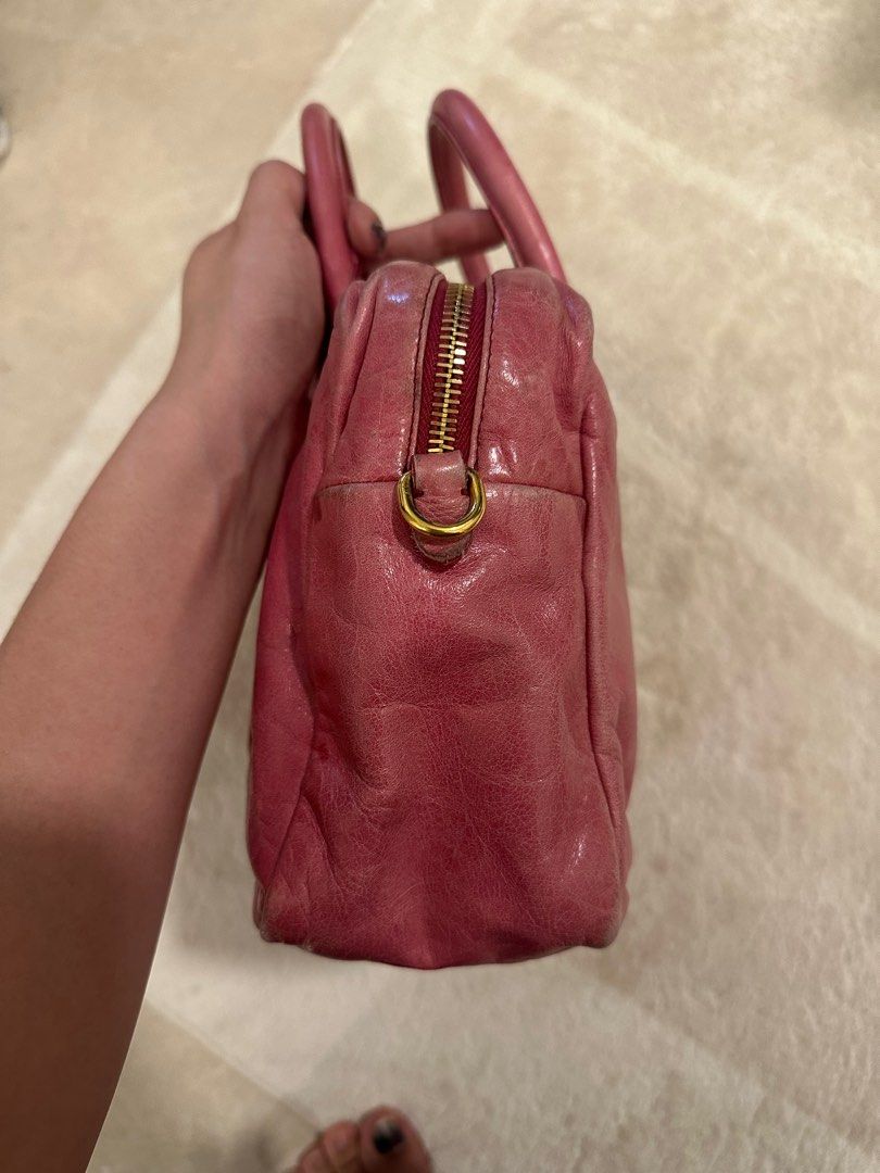 Vintage Miu Miu bag in Pink (Category: Bags & Wallets) located in Singapore. Submitted by coffeelover2233 (Listing ID 1380778675, Image 3). Description: Vintage Miu Miu bag in Pink Comes with strap Purchased from Japanese vintage store 26x17x9cm In good condition, wear on exterior/corners, slight wear on hardware.