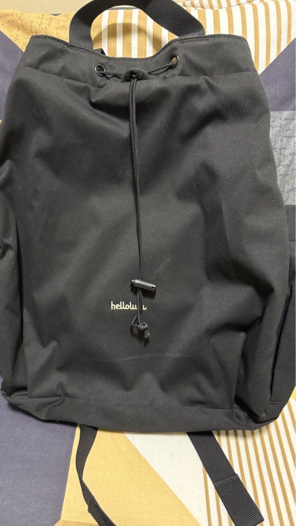 Black Drawstring Backpack (Category: Backpacks) located in Singapore. Submitted by sellerade (Listing ID 1381016304, Image 1). Description: Black drawstring backpack. Features a drawstring closure and a top handle. The bag has a small logo on the front. It appears to be in good condition with minimal signs of wear. Perfect for everyday use..