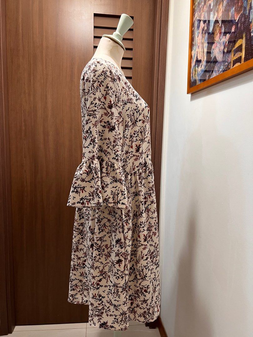 YOCO Floral Ruffle-Sleeve Dress (Category: Dresses) located in Singapore. Submitted by minni3scloset (Listing ID 1381029713, Image 3). Description: Delicate and breezy, this floral ruffle-sleeve dress by YOCO features a soft cream base adorned with vintage-inspired floral motifs in muted red, blush, and charcoal tones. The relaxed silhouette, gathered waist, and flared sleeves create a romantic and flattering look, perfect for casual brunches or 