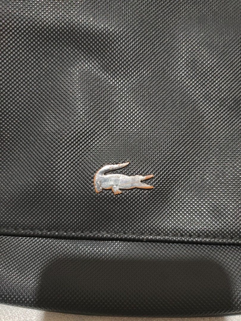 Lacoste Sling/Crossbody Bag (Category: Cross-body Bags) located in Quezon City. Submitted by jhaneth21 (Listing ID 1380955750, Image 2). Description: Sling) Crossbody Bag 2 Main Compartments Zip & Organizer Pocket Inside Lacoste Tags and Logos Adjustment Strap Well Used Size: 10" x 7.5".