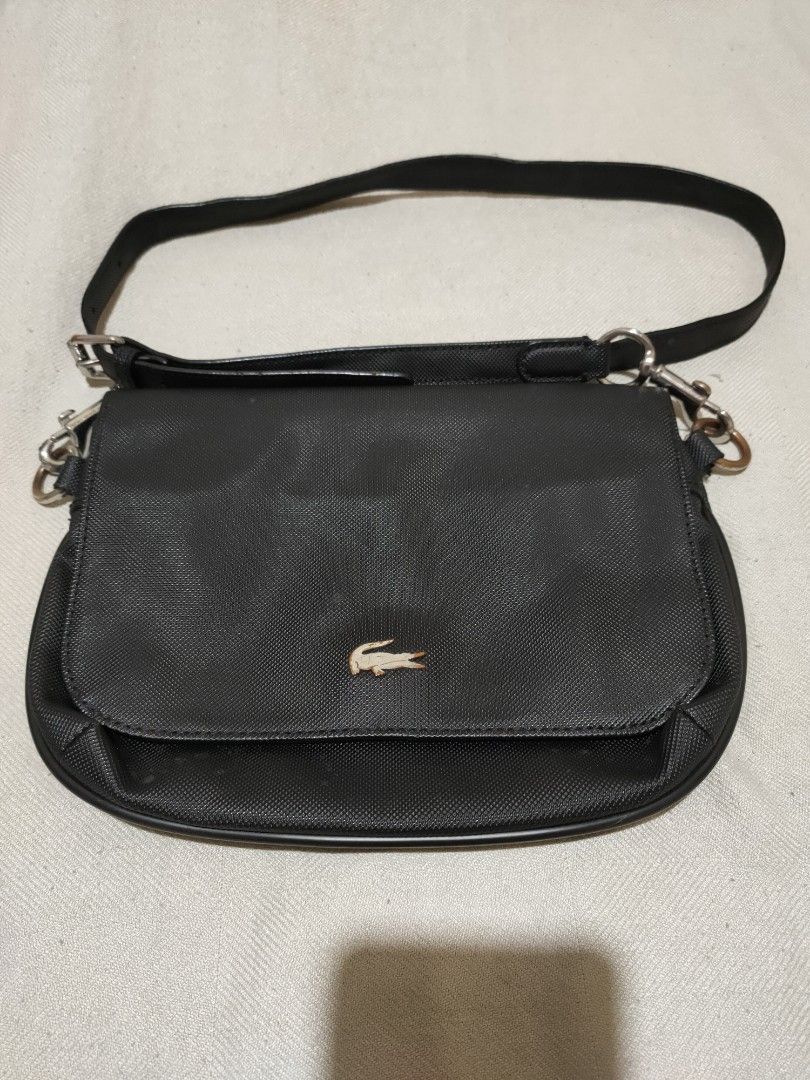 Lacoste Sling/Crossbody Bag (Category: Cross-body Bags) located in Quezon City. Submitted by jhaneth21 (Listing ID 1380955750, Image 1). Description: Sling) Crossbody Bag 2 Main Compartments Zip & Organizer Pocket Inside Lacoste Tags and Logos Adjustment Strap Well Used Size: 10" x 7.5".