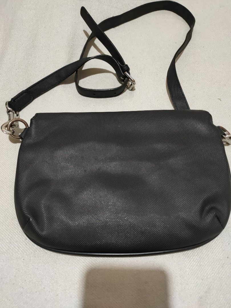 Lacoste Sling/Crossbody Bag (Category: Cross-body Bags) located in Quezon City. Submitted by jhaneth21 (Listing ID 1380955750, Image 3). Description: Sling) Crossbody Bag 2 Main Compartments Zip & Organizer Pocket Inside Lacoste Tags and Logos Adjustment Strap Well Used Size: 10" x 7.5".