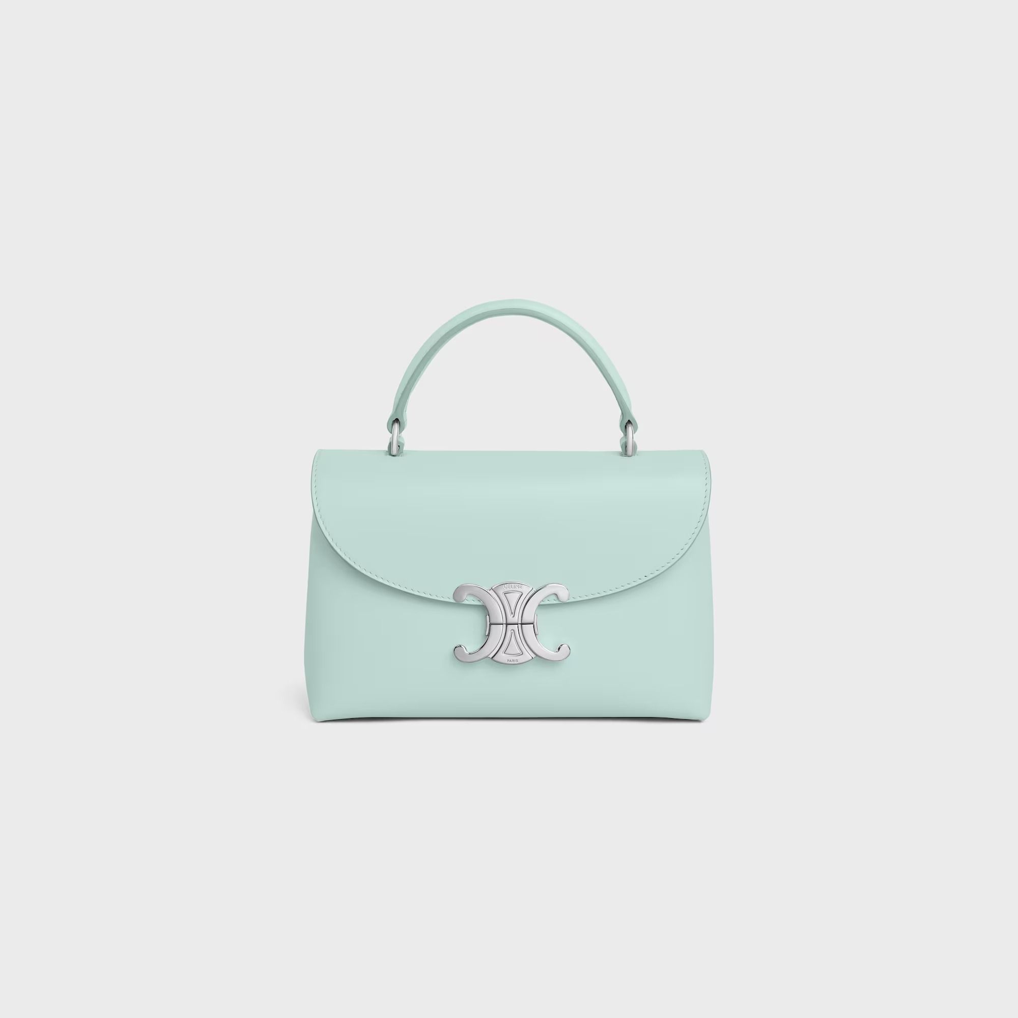 Celine TEEN NINO BAG IN SMOOTH SATINATED CALFSKIN - Light Acqua (Category: Bags & Wallets) located in Singapore. Submitted by ms__pinky (Listing ID 1381107124, Image 1). Description: Stunning Celine Triomphe Small handbag in a beautiful mint green color. Features a top handle and a signature Triomphe clasp. This bag is perfect for adding a touch of luxury to any outfit. Comes in brand new condition. Retail Price: S$ 4,550 8.1 x 5.1 x 3.1 IN (20.5