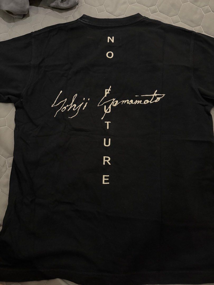 New Era x Yohji Yamamoto Black T-Shirt (Category: Tshirts & Polo Shirts) located in Singapore. Submitted by canshsm (Listing ID 1381270495, Image 3). Description: Authentic New Era x Yohji Yamamoto black t-shirt. Features a small New Era logo on the sleeve and a Yohji Yamamoto signature print on the back. Made from 100% cotton. Size is YL..