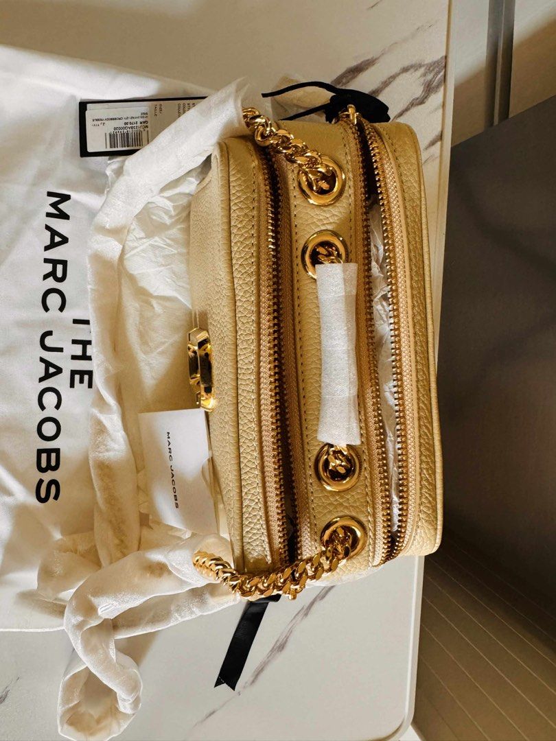 Authentic Marc Jacobs The Glam Shot Bag (Category: Luxury Bags & Wallets) located in Quezon City. Submitted by anbaksing (Listing ID 1381315347, Image 2). Description: Brand new authentic original Marc Jacobs The Glam Shot camera bag with chain Color: Beige with gold chain Motive: Monogram solid colour Composition: 100% pelle bovina Height: 13 cm Length: 21 cm Depth: 8 cm Shoulder Bag: 118 cm Bought from Qatar, please zoom in to see price tag. In