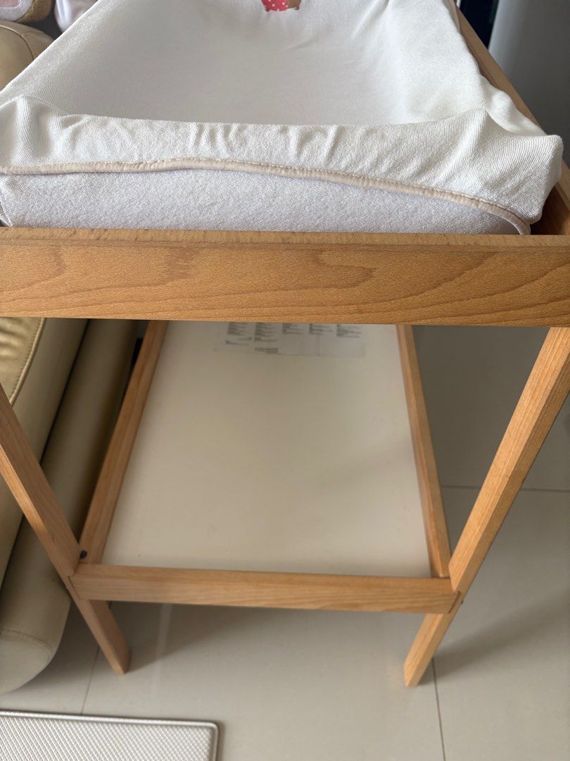 IKEA Changing Table (Category: Changing Tables & Stations) located in Singapore. Submitted by divinelife (Listing ID 1381462839, Image 1). Description: Includes the changing pad (some parts a bit deflated and comes with the cover). Features a shelf for storage. Solid wood frame. Clean and ready for use. Perfect for a nursery or baby's room. Use for 1year only baby has grown. Self-collected. .