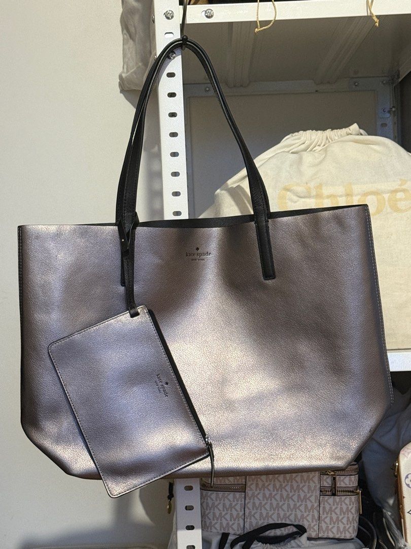 Kate Spade Arch Place Mya - Reversible Bag (Category: Tote Bags) located in Santo Tomas. Submitted by ella0726 (Listing ID 1381384083, Image 1). Description: Authentic; Bought in Europe Color: silver metallic / black Dimension: 12.4”h x 18.5”w x 6.3”d Drop length: 9” refined grain leather Unlined Open top tote Reversible Comes with removable pouch No dustbag .