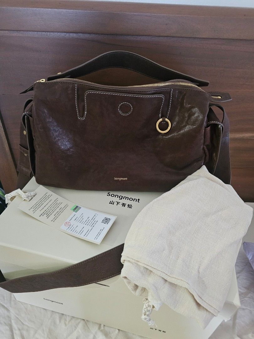 Songmont Yore Camera Bag (Category: Luxury Bags & Wallets) located in Taguig. Submitted by riello (Listing ID 1381355004, Image 1). Description: brand new price is 30k, guaranteed original bought last year from official songmont website. no flaws but minimal signs of use. - Material: Vegetable-Tanned Leather - Interior Lining: Fabric - Hardware: 304 Stainless Steel Vacuum Electroplated Hardware - Dimension: L 30cm/11.81" * W 13cm/5.12" * H 17cm/6